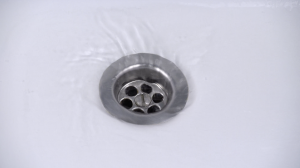 Water flows smoothly down a drain, showing how Rhino Rooter clears clogs and helps drains work well.