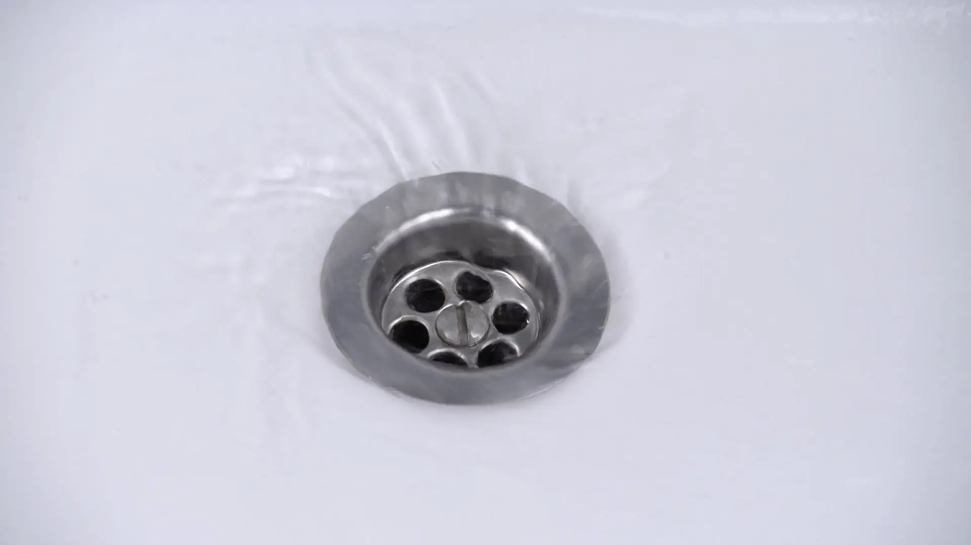 Water flows smoothly down a drain, showing how Rhino Rooter clears clogs and helps drains work well.