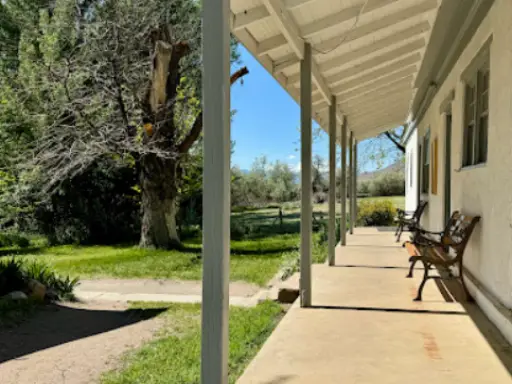A welcoming porch beside a white building shows a relaxing place served by Rhino Rooter, trusted plumbers in The Wasatch Front.