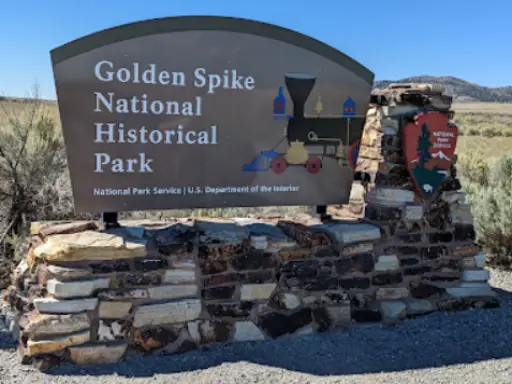 Rhino Rooter visits Golden Spike National Historical Park, marked by a stone sign and park emblem—an important Wasatch Front landmark.