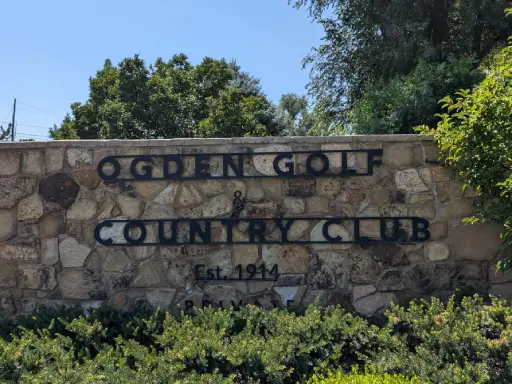 A welcoming entrance sign for Ogden Golf & Country Club shows the pride and care taken by professionals, like Rhino Rooter with drain cleaning.