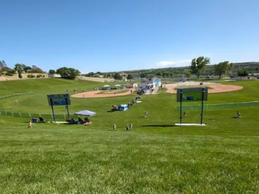A baseball event sponsored by Rhino Rooter brings people together, with tents and hydro jetting demos on a sunny day.