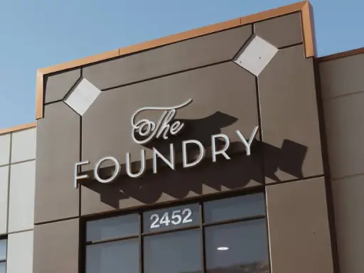 Rhino Rooter location with The Foundry sign at 2452, showing a modern place for sewer repair in The Wasatch Front.