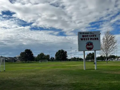 A grassy field at Roy City West Park welcomes visitors, where Rhino Rooter has helped keep the park clean and safe.