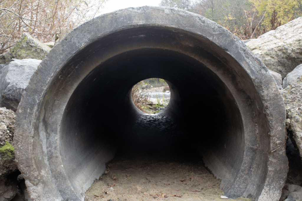 A clean, open drainage pipe ready for work, showing a clear need for Rhino Rooter’s expert sewer cleaning services.