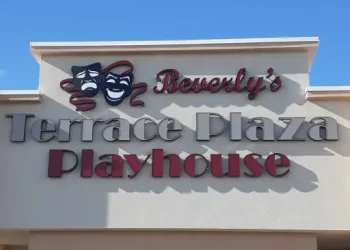 A theater sign for Beverly’s Terrace Plaza Playhouse stands on a building near Rhino Rooter, a trusted plumber known for hydro jetting and pipe work.