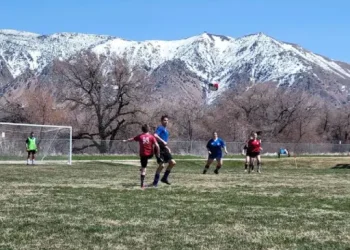 Teens enjoy a soccer game outside, showing active community life near The Wasatch Front, where Rhino Rooter serves local plumbing needs.