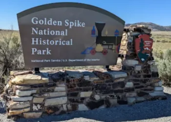 Rhino Rooter visits Golden Spike National Historical Park, marked by a stone sign and park emblem—an important Wasatch Front landmark.