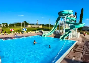 People enjoy a clean, well-maintained pool and water slides at a facility cared for by Rhino Rooters expert team.