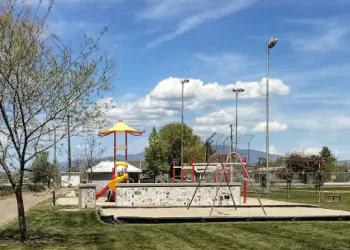 A playground in a grassy park invites families to relax and play, making it a nice spot for Rhino Rooter workers on break.